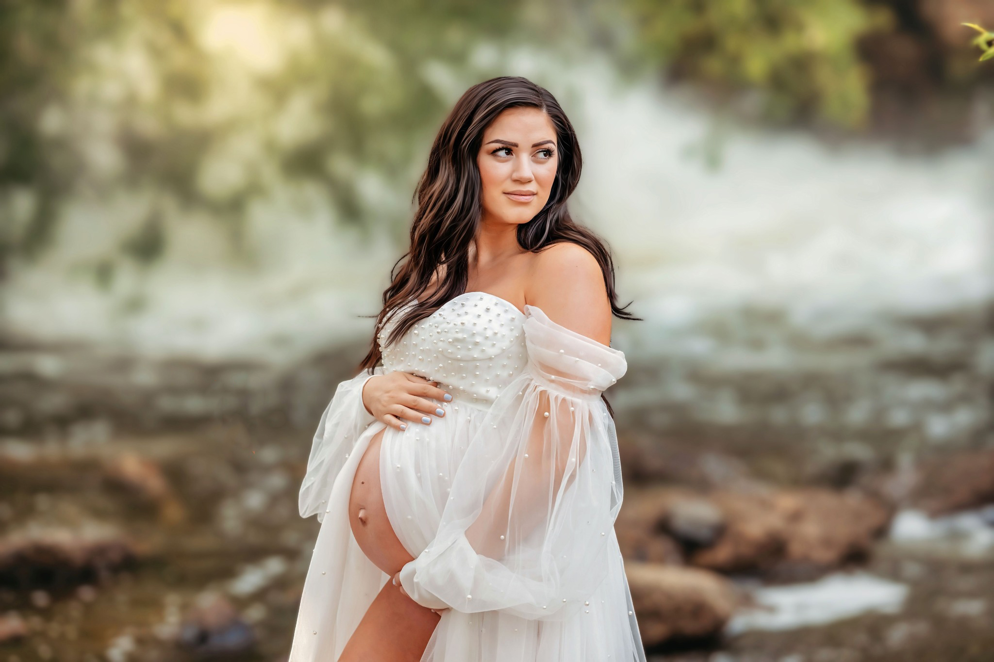 Pretty mom posing in white maternity dress after her Arvada pediatricians appointment.