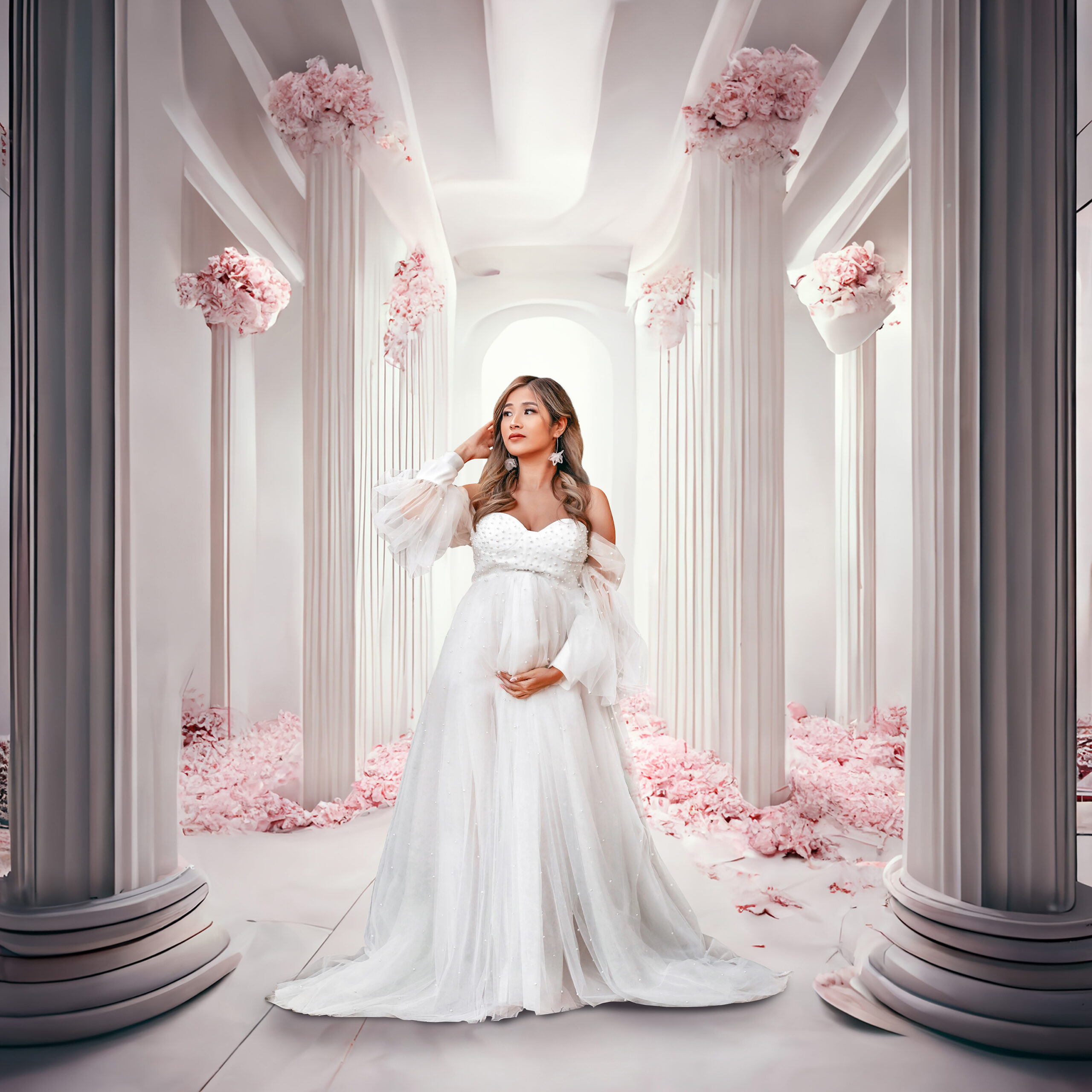 Beautiful momma to be posing in gorgeous flowy white dress at her denver maternity photo session.