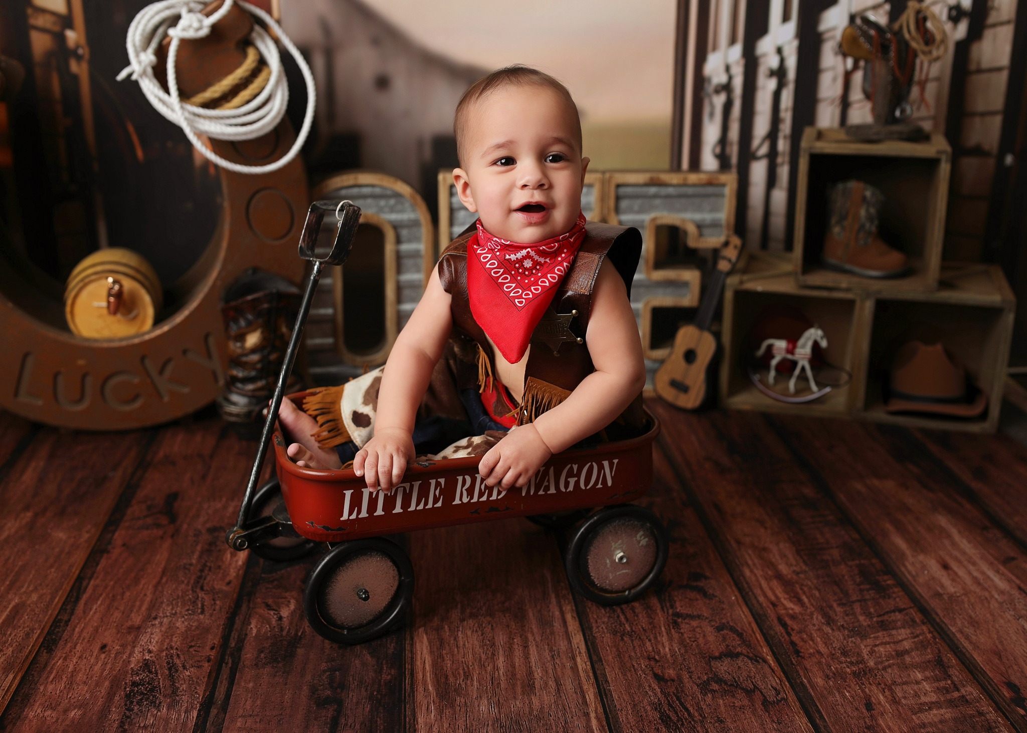 Little Cowboy enjoying hid denver children's photography session at H&N Photography studio. 