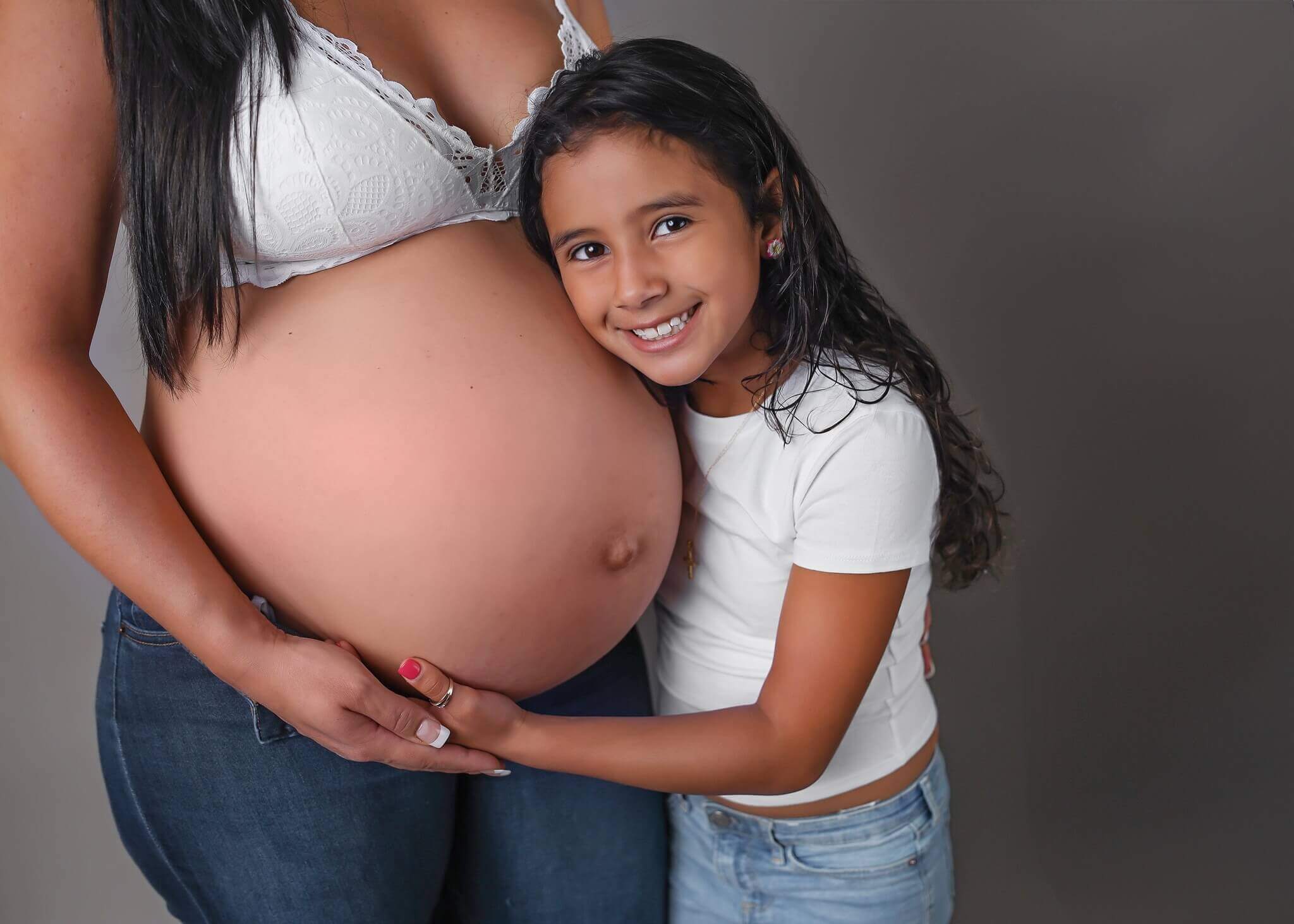 Pregnant momma and daughter celebrating the new addition to their family.