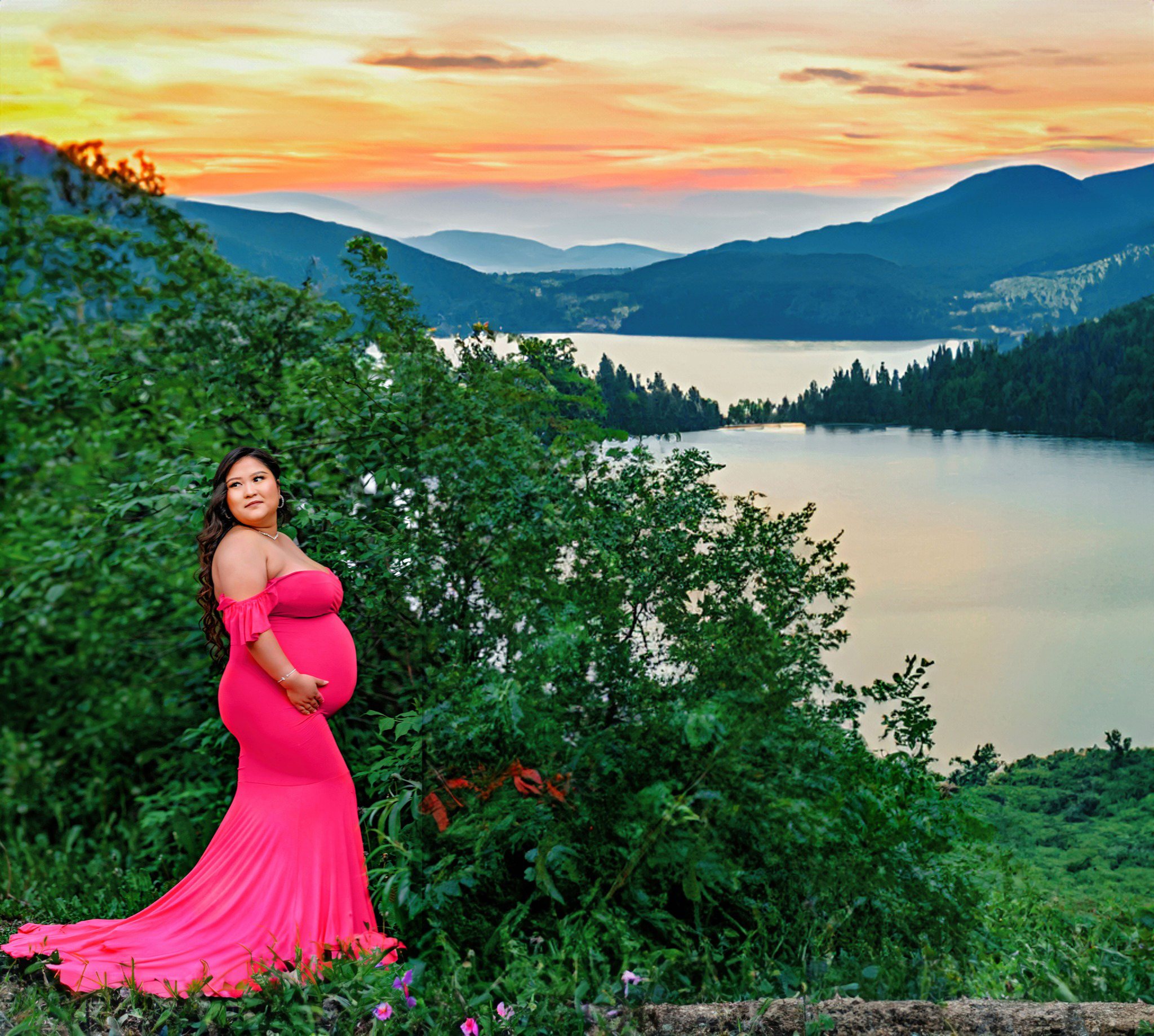 A Pregnant woman posing in a pink maternity dress right after her Lakewood pediatricians appointment.