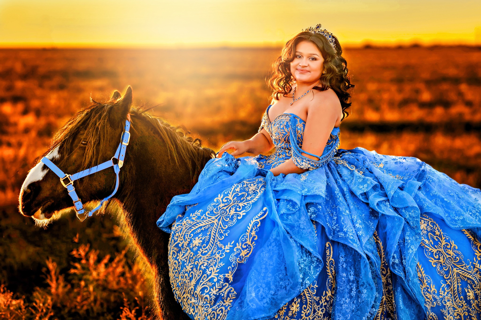 Beautiful 16-year-old Quinceanera posing in her blue dress after picking up her horse from horse boarding arvada.