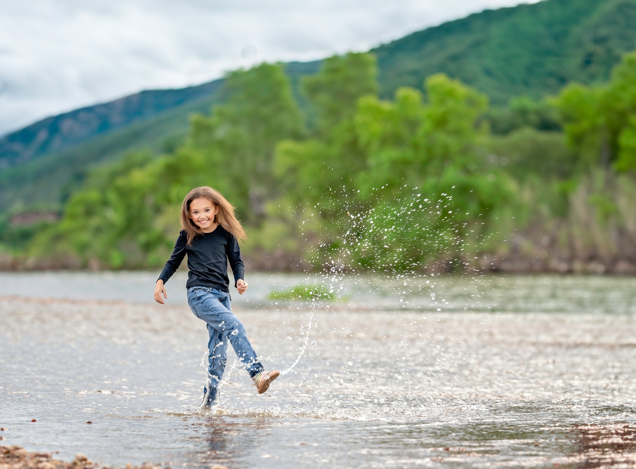 Cool kiddo enjoying herself playing in the water at her Denver kids photo session.