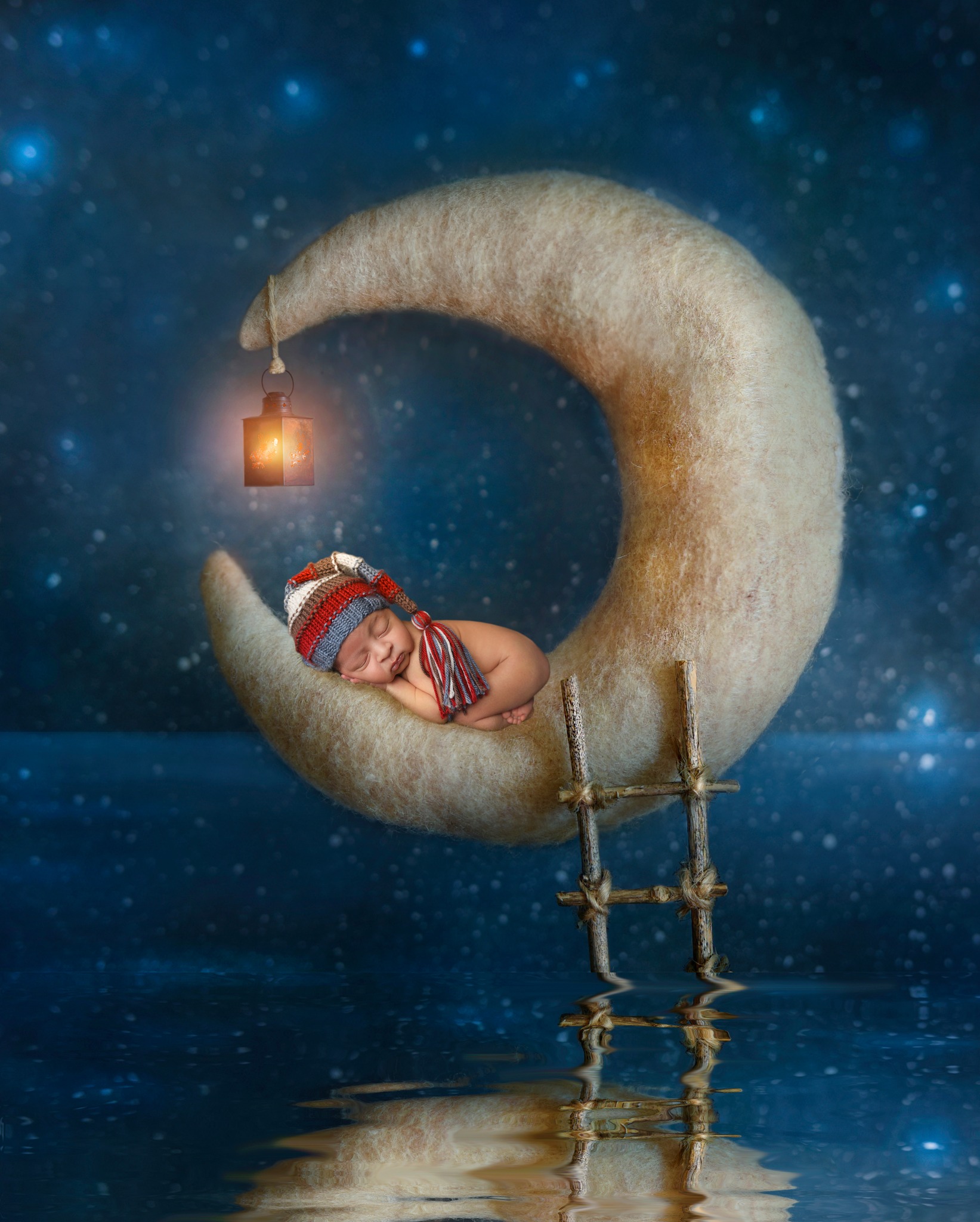 Sweet sleepy newborn resting on his composite moon image.