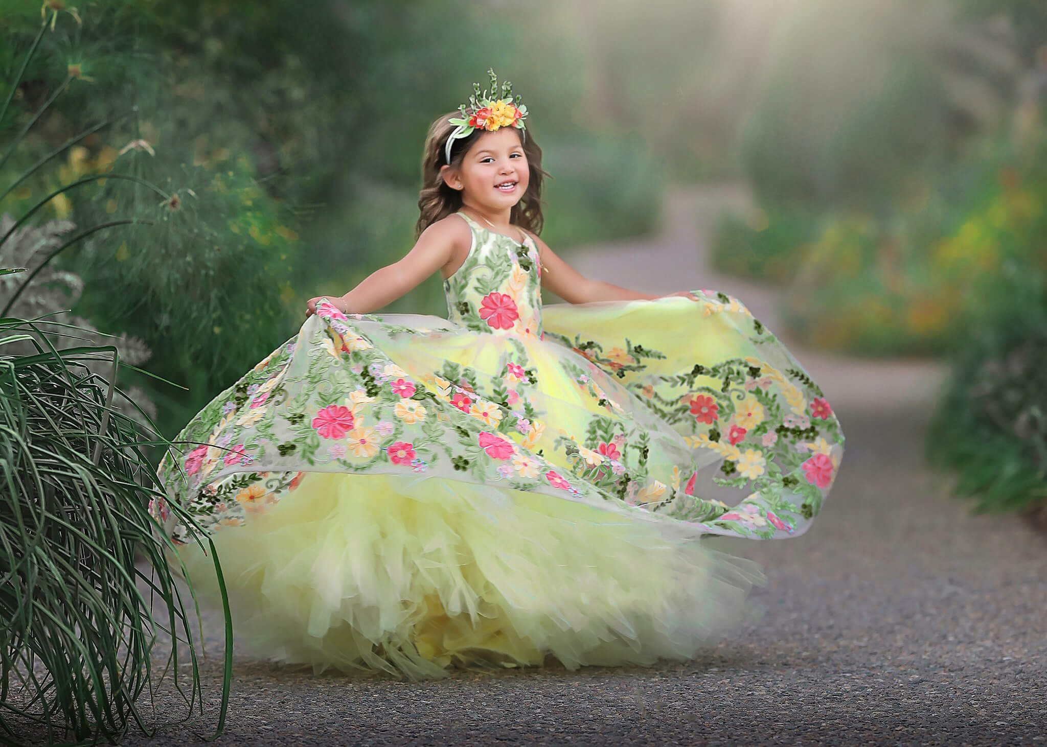 Sweet young child spinning in her yellow flowy dress.